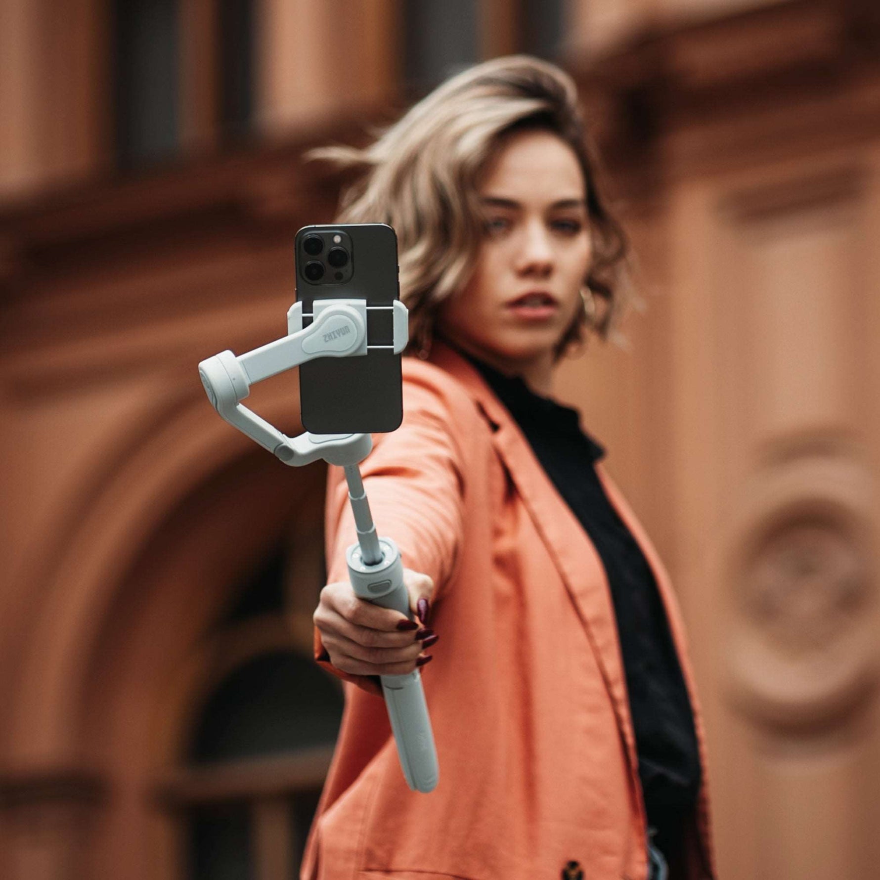 ZHIYUN Smooth Q4 handheld shooting gimbal in portrait orientation mode with magnetic fill light