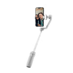 Content creator using ZHIYUN Smooth Q4 mobile phone gimbal with built‑in fill light in low light